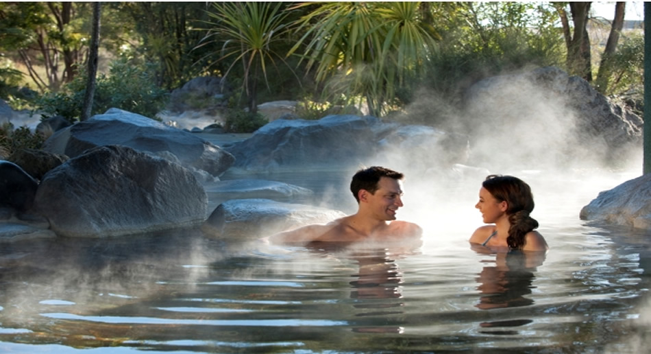 Two people relaxing in a hot mineral pool